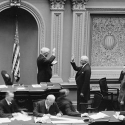 On January 4, 1939, in the U.S. Senate Chamber, Vice President John Nance Garner issues the oath of office to Senator Elmer Thomas of Oklahoma.