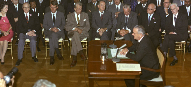 President Lyndon Johnson signs the Civil Rights Act of 1964.