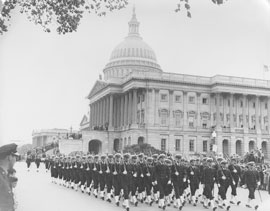 Photo of naval troops marching past Capitol Building.