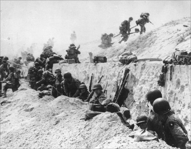Soldiers of the U.S. Army’s 4th Infantry Division at a seawall on Utah Beach, June 6, 1944.