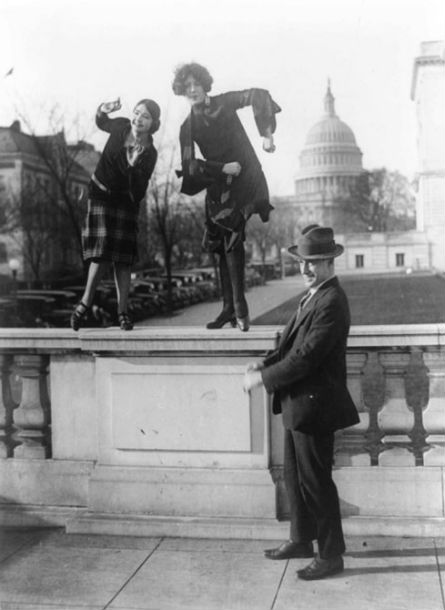 Two women and a man dancing the Charleston in front of the Capitol